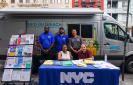 HPD Van & workers at a table